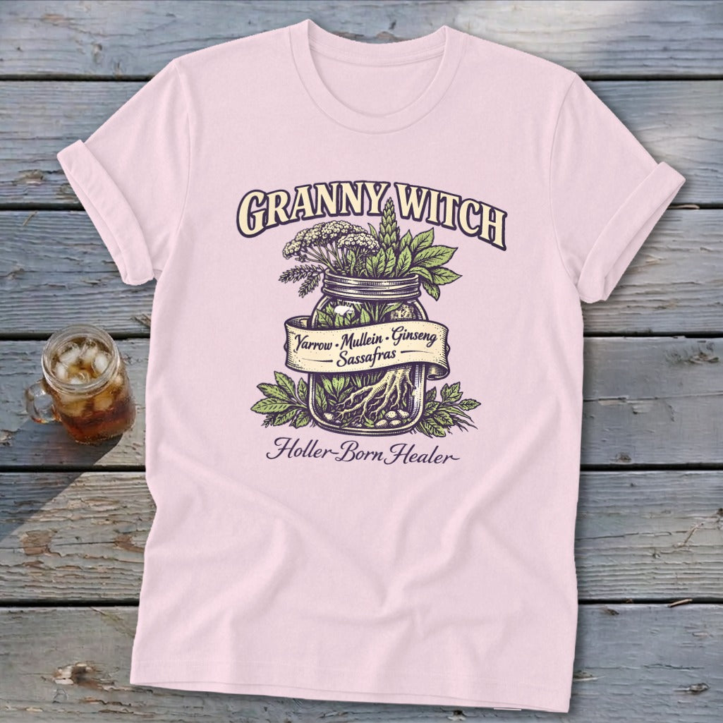 Pink t-shirt with "Granny Witch Holler-Born Healer" and a jar of herbs: Yarrow, Mullein, Ginseng, Sassafras.