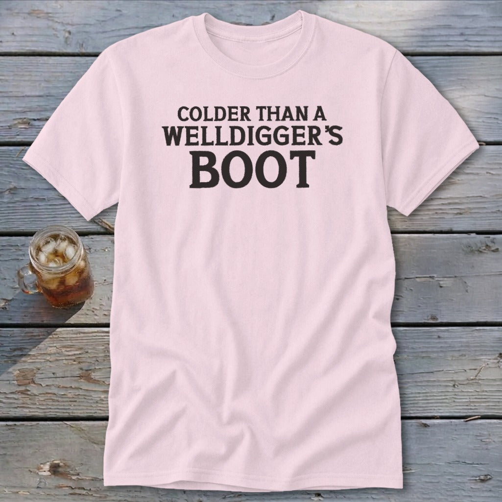 Light pink t-shirt with black text "COlder THAN A WELLDIGGER'S BOOT".