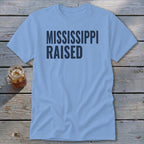 Light blue t-shirt with "MISSISSIPPI RAISED" text.