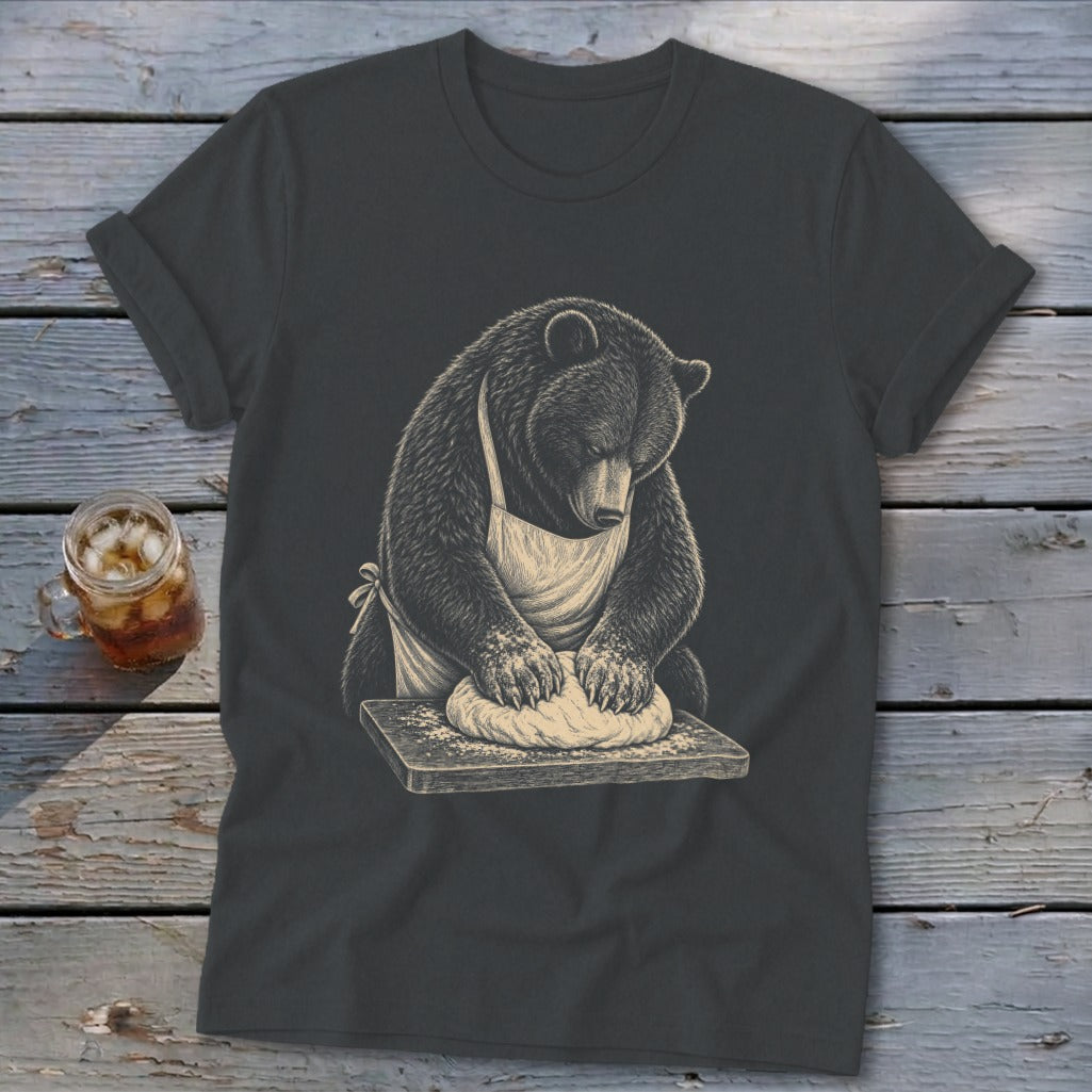 Bear wearing an apron kneading dough on a wooden board, charcoal t-shirt design.