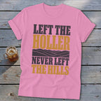 Pink t-shirt with "Left the holler, never left the hills" text and mountain graphic.