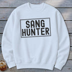 White sweatshirt with black distressed text that reads "SANG HUNTER" in a rectangular box.