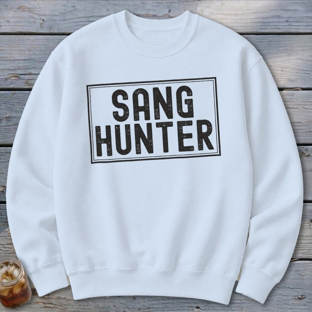 White sweatshirt with black distressed text that reads "SANG HUNTER" in a rectangular box.