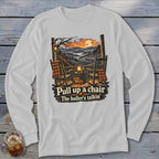 Graphic on shirt with rocking chairs, pumpkins, and text "Pull up a chair The holler's talkin'".