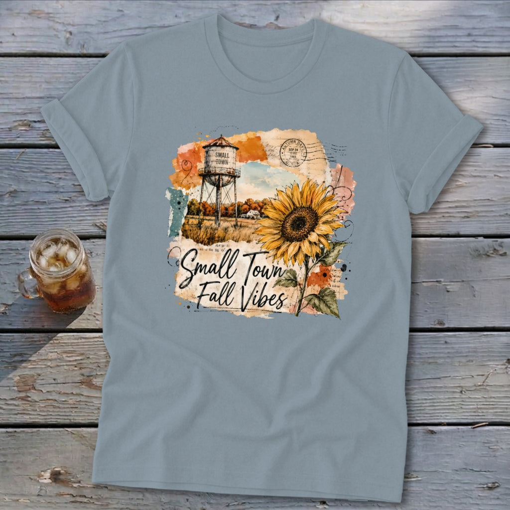 T-shirt graphic with water tower, sunflower, and text "Small Town Fall Vibes".