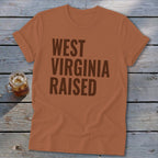 Orange t-shirt with "WEST VIRGINIA RAISED" text in dark brown.