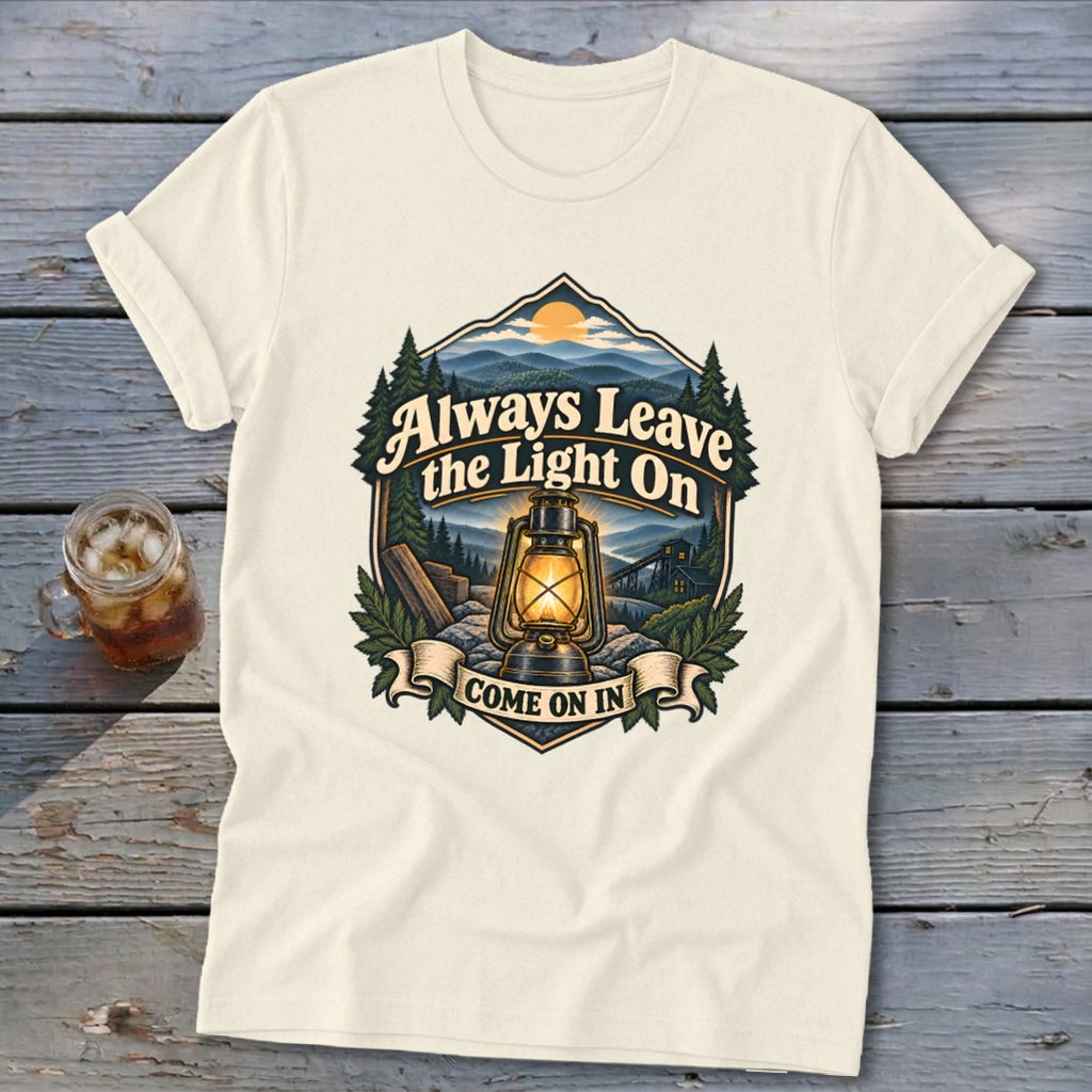 Cream t-shirt with "Always Leave the Light On COME ON IN" text and a lantern graphic.