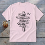 A light pink t-shirt with a black graphic of directional wooden signs pointing different ways with humorous text.