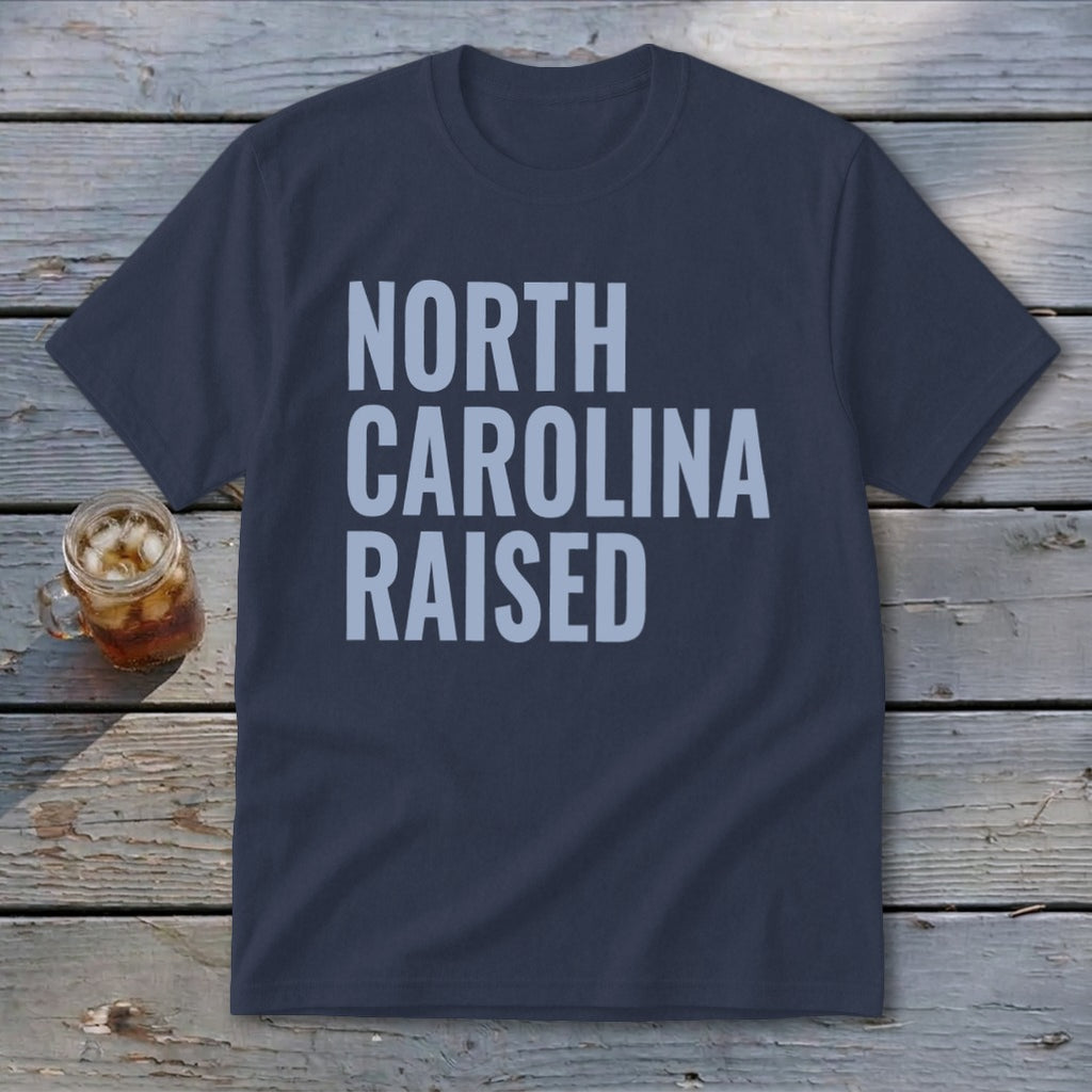 Navy t-shirt with "NORTH CAROLINA RAISED" in light blue text.