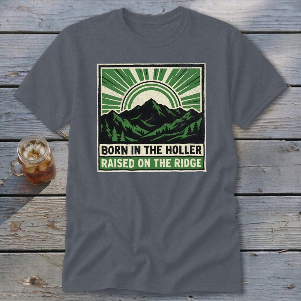 Charcoal gray t-shirt featuring a green mountain graphic and text reading Born in the Holler Raised on the Ridge.