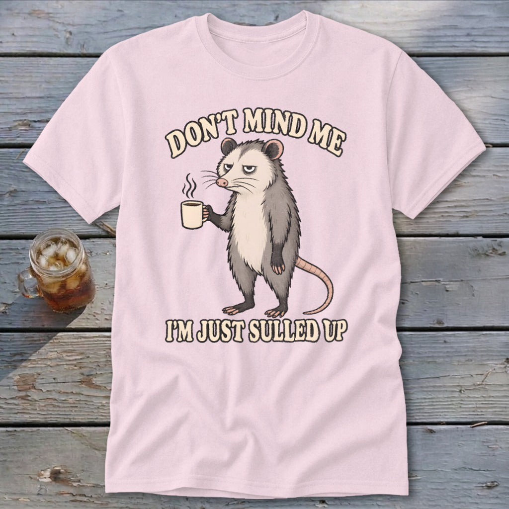 Pink t-shirt with opossum holding coffee mug and text "DON'T MIND ME I'M JUST SULLED UP".