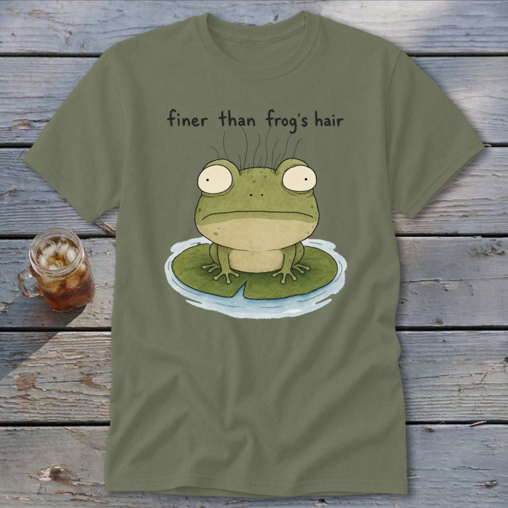 An olive green t-shirt featuring an illustration of a wide-eyed frog on a lily pad with the text "finer than frog's hair."