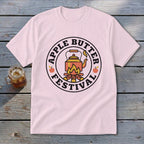 Pink t-shirt with Apple Butter Festival logo featuring a kettle over a campfire.