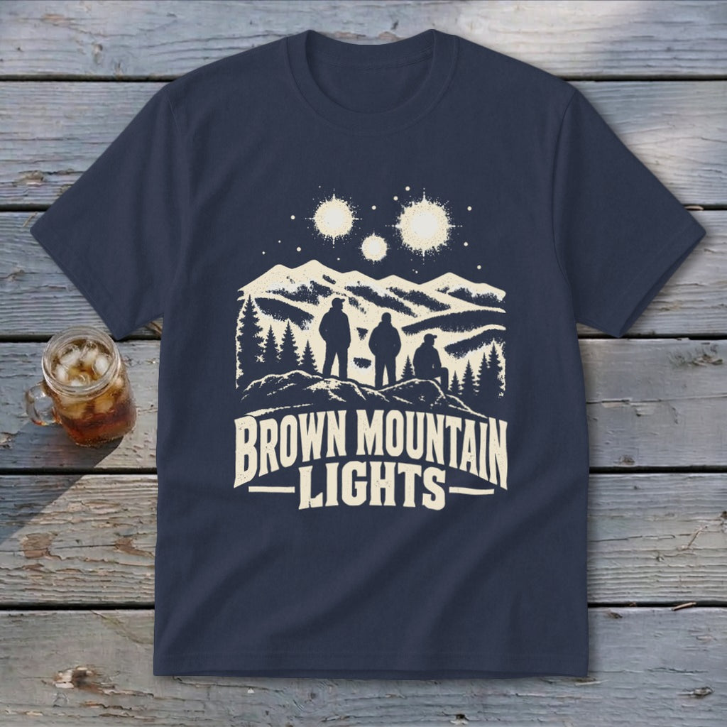Dark blue t-shirt featuring a graphic of three figures watching glowing lights over mountains, with the text "Brown Mountain Lights".
