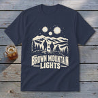 Dark blue t-shirt featuring a graphic of three figures watching glowing lights over mountains, with the text "Brown Mountain Lights".