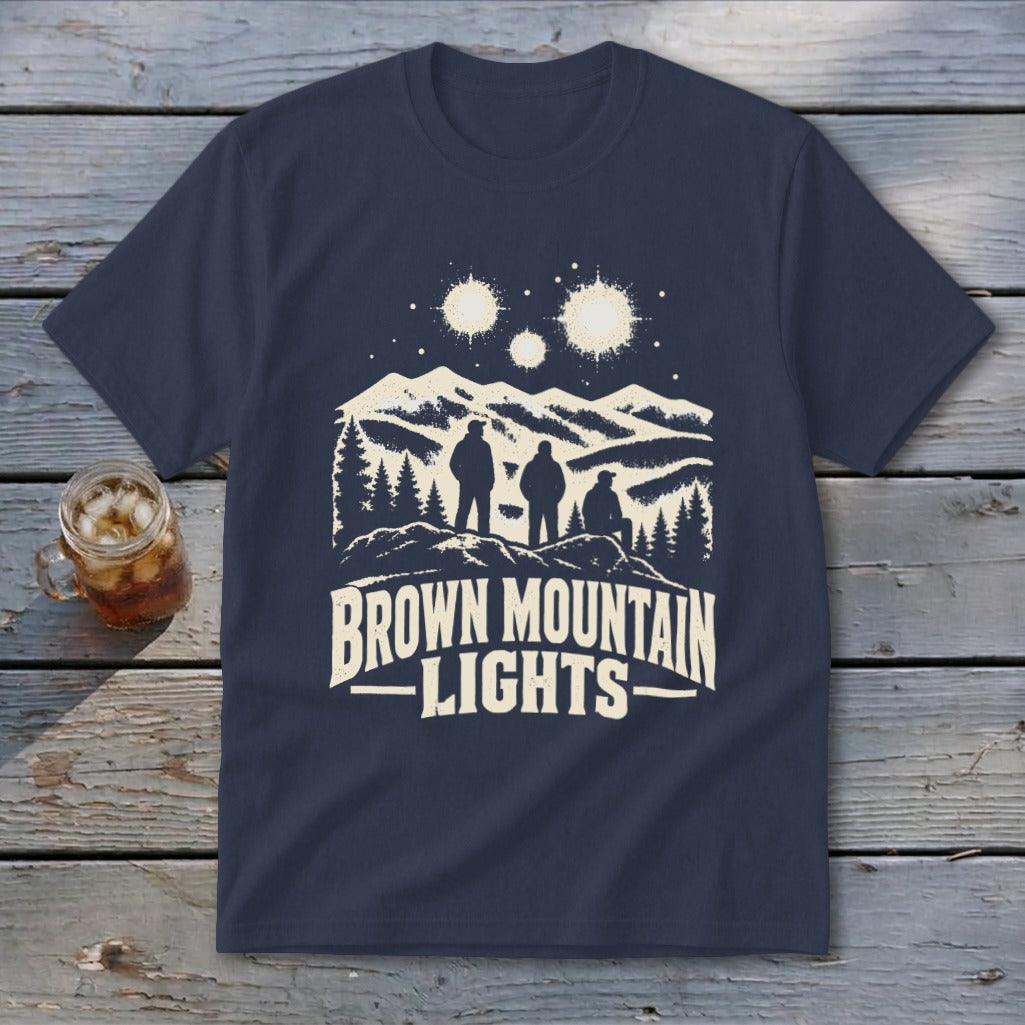 Dark blue t-shirt featuring a graphic of three figures watching glowing lights over mountains, with the text "Brown Mountain Lights".