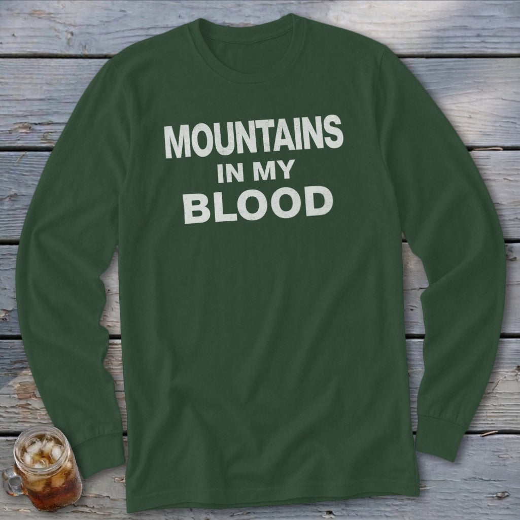 Green long-sleeve shirt with white text "MOUNTAINS IN MY BLOOD".