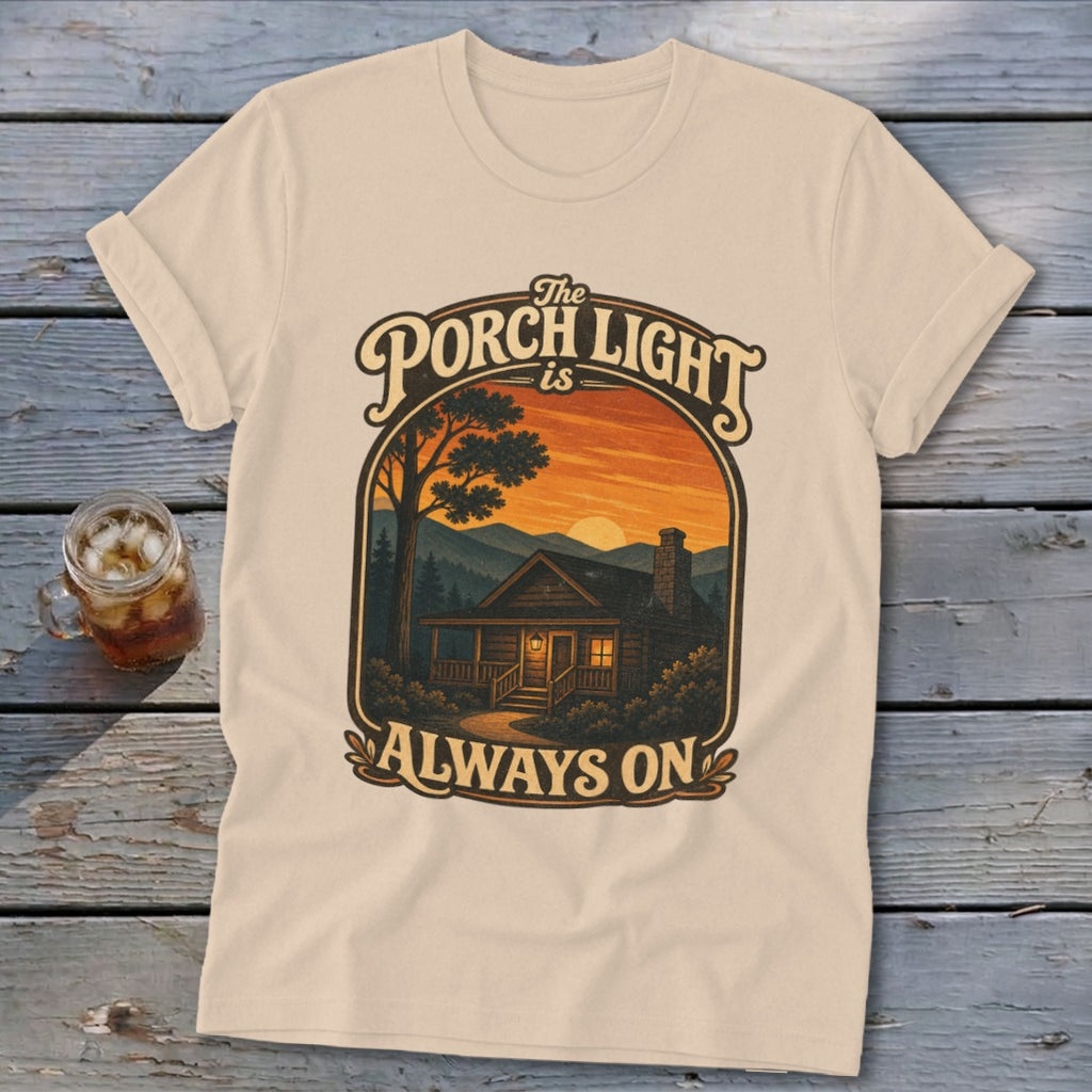 Cream t-shirt with "The Porch Light is Always On" text and cabin graphic.