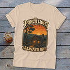 Cream t-shirt with "The Porch Light is Always On" text and cabin graphic.