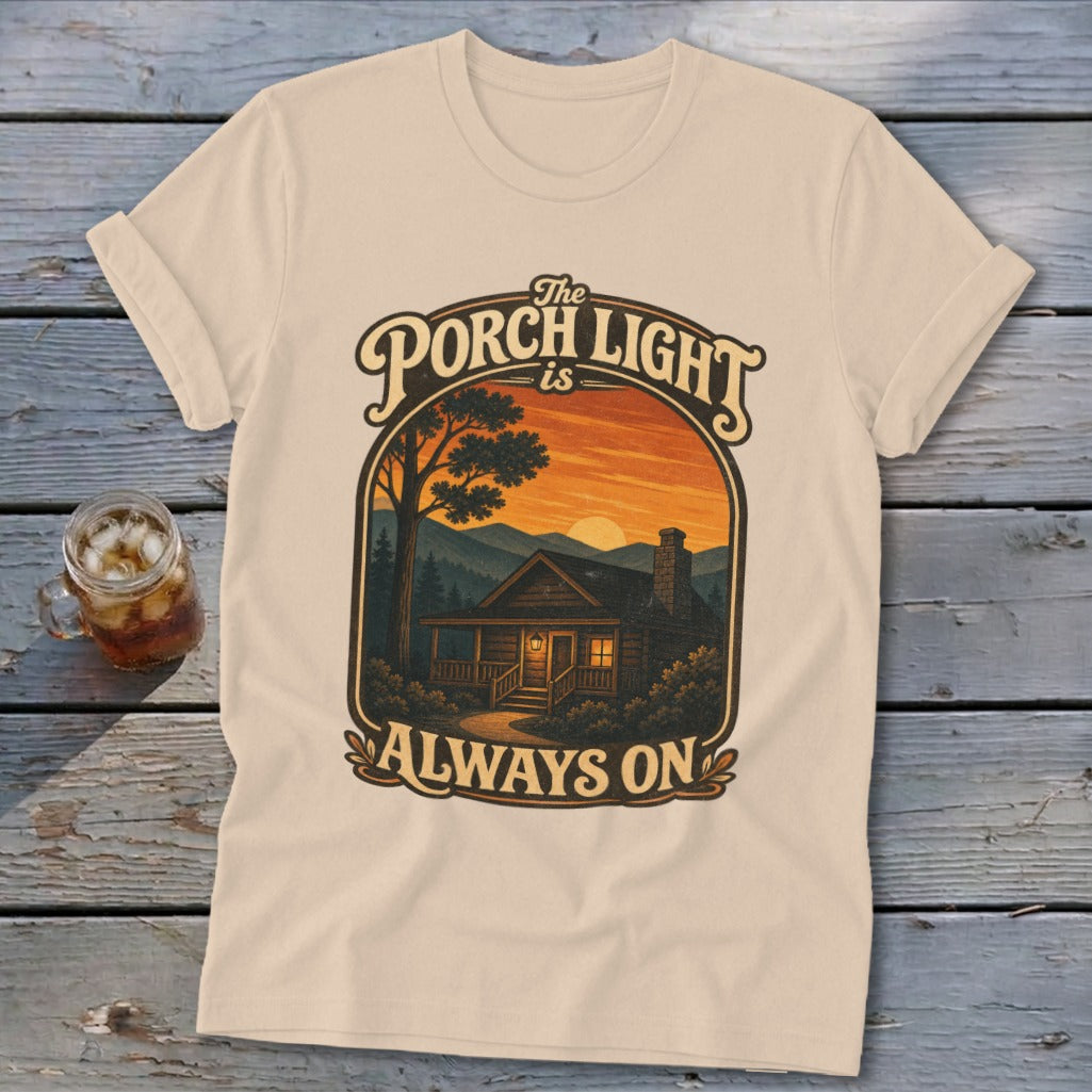 Cream t-shirt with "The Porch Light is Always On" text and cabin graphic.