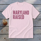 Pink t-shirt with "MARYLAND RAISED" text in maroon.