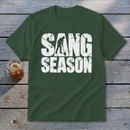 Dark green short-sleeve t-shirt with distressed white text reading SANG SEASON and a graphic of a person digging.