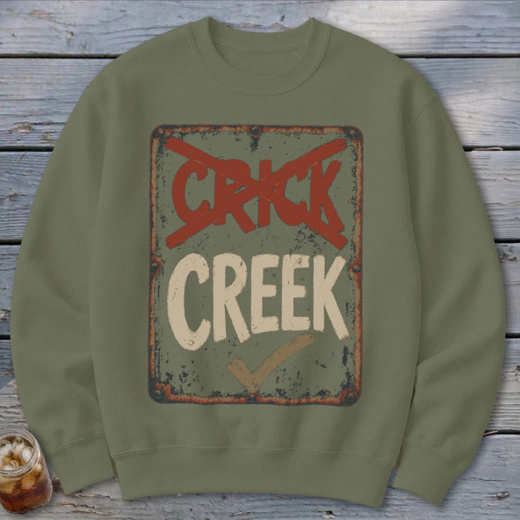 Olive green crewneck sweatshirt with distressed "CRICK CREEK" sign graphic.