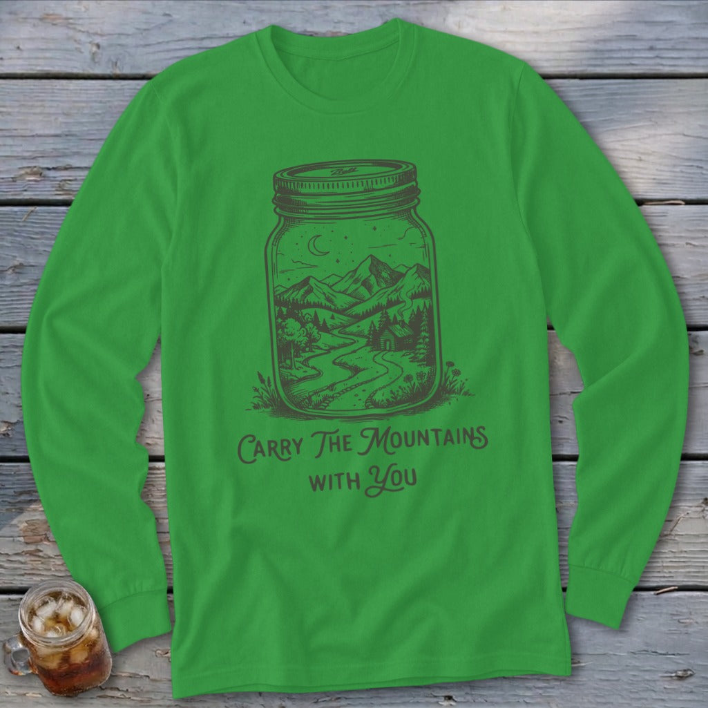 Kelly green long-sleeved shirt with a mason jar containing a mountain landscape and the text Carry The Mountains With You.