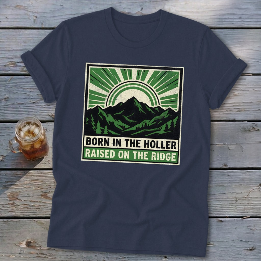 Dark blue t-shirt with a green graphic featuring mountains and the text "BORN IN THE HOLLER RAISED ON THE RIDGE".