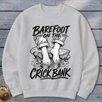 Sweatshirt with "Barefoot on the Crick Bank" text and illustration of bare feet.