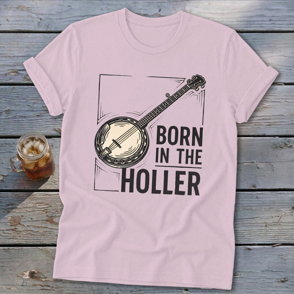 Pink t-shirt with banjo graphic and text "BORN IN THE HOLLER".