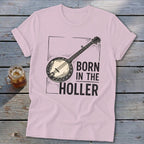 Pink t-shirt with banjo graphic and text "BORN IN THE HOLLER".