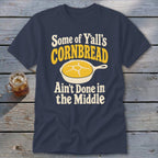 Dark blue t-shirt featuring the text "Some of Y'all's Cornbread Ain't Done in the Middle" and a frying pan graphic.