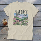Cream t-shirt with "Blue Ridge Bloom" text and mountain and flower graphic.