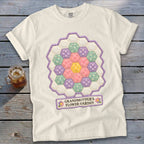 White t-shirt with a hexagonal floral quilt design and the text "GRANDMOTHER'S FLOWER GARDEN."
