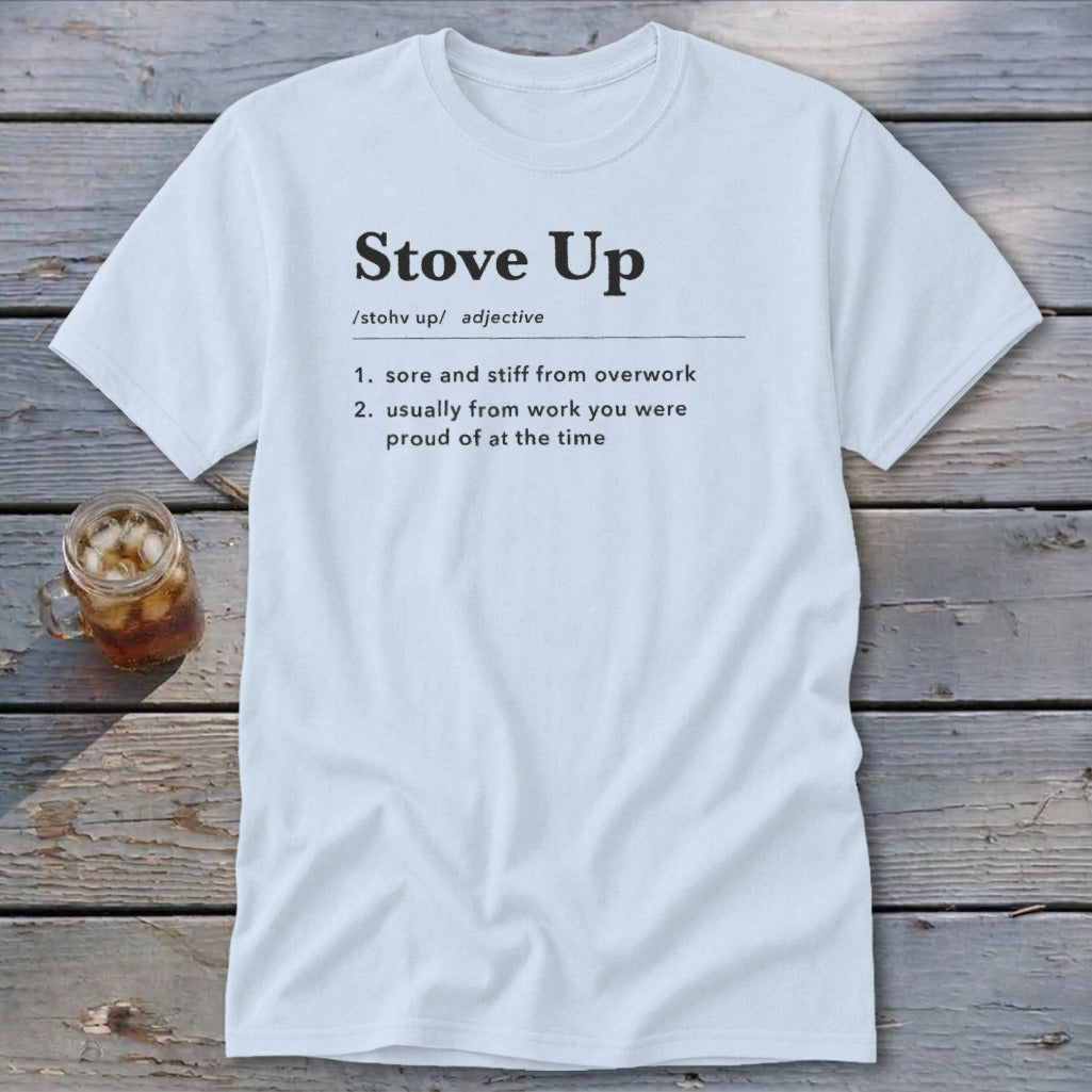 Light gray t-shirt with a dictionary definition print that reads Stove Up on a rustic wooden background.