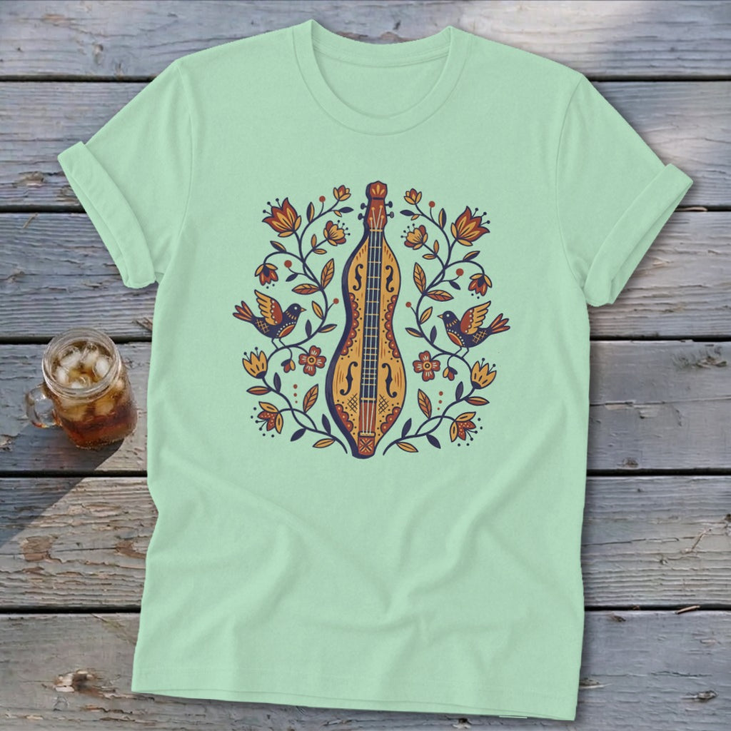 Light green t-shirt with a graphic of a lute surrounded by flowers and birds.