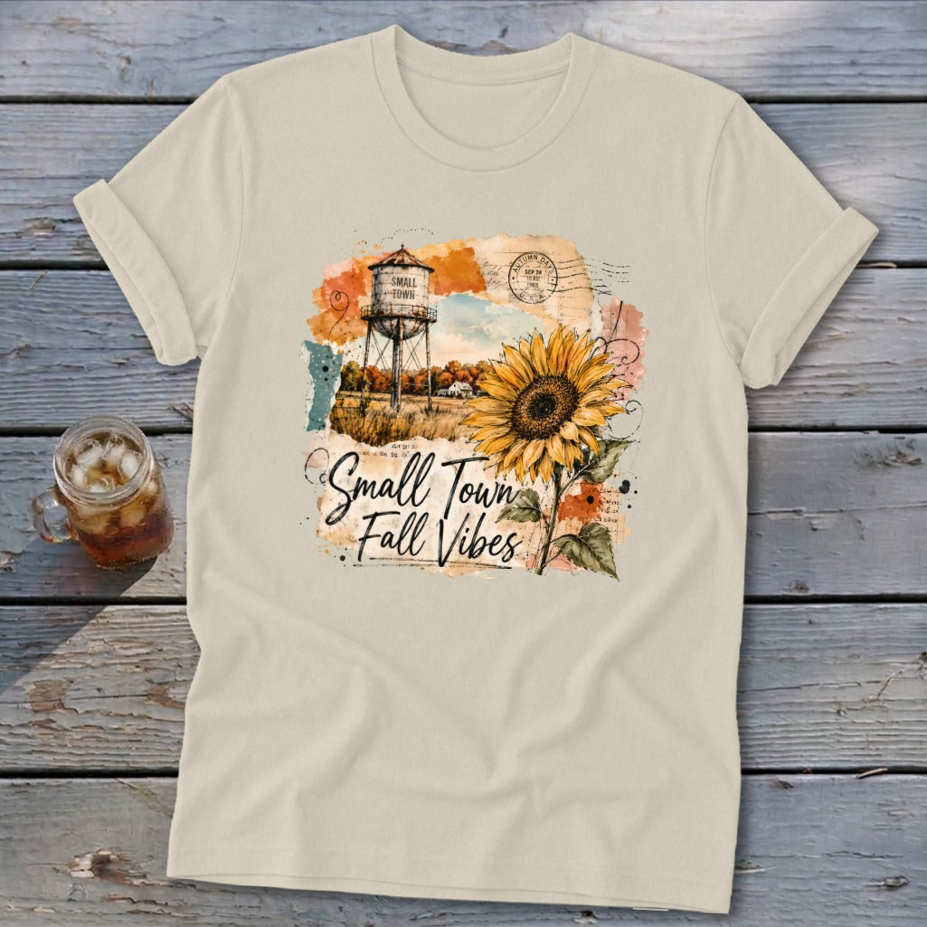 T-shirt with "Small Town Fall Vibes" text, water tower, and sunflower graphic.