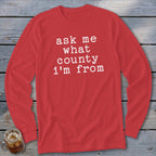 Red long-sleeve shirt with white text saying "ask me what county i'm from".