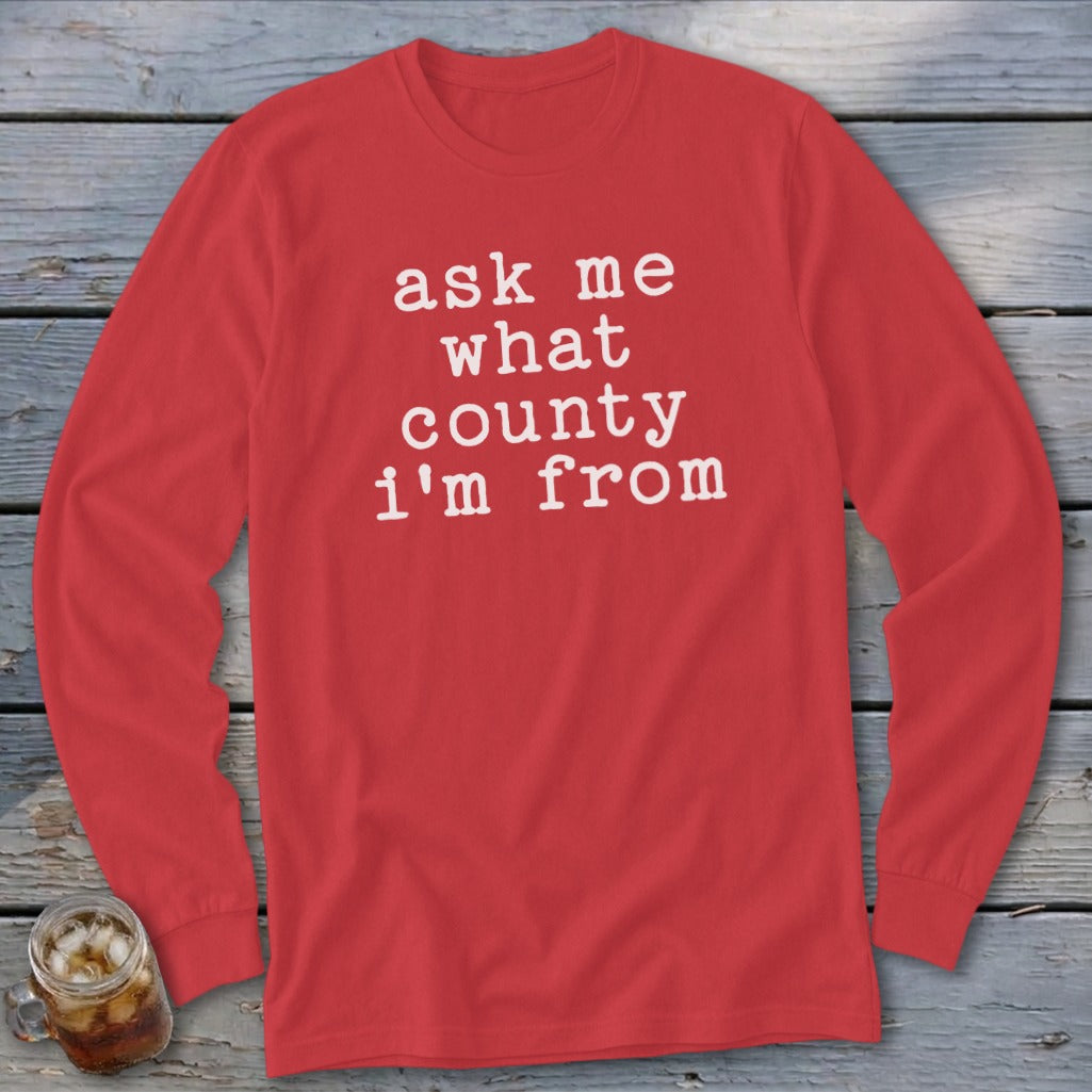 Red long-sleeve shirt with white text saying "ask me what county i'm from".