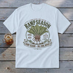 White t-shirt with RAMP SEASON graphic featuring ramps, mountains, and text.