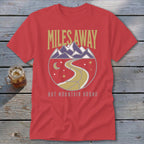 Red t-shirt with "MILES AWAY BUT MOUNTAIN BOUND" text and mountain graphic.