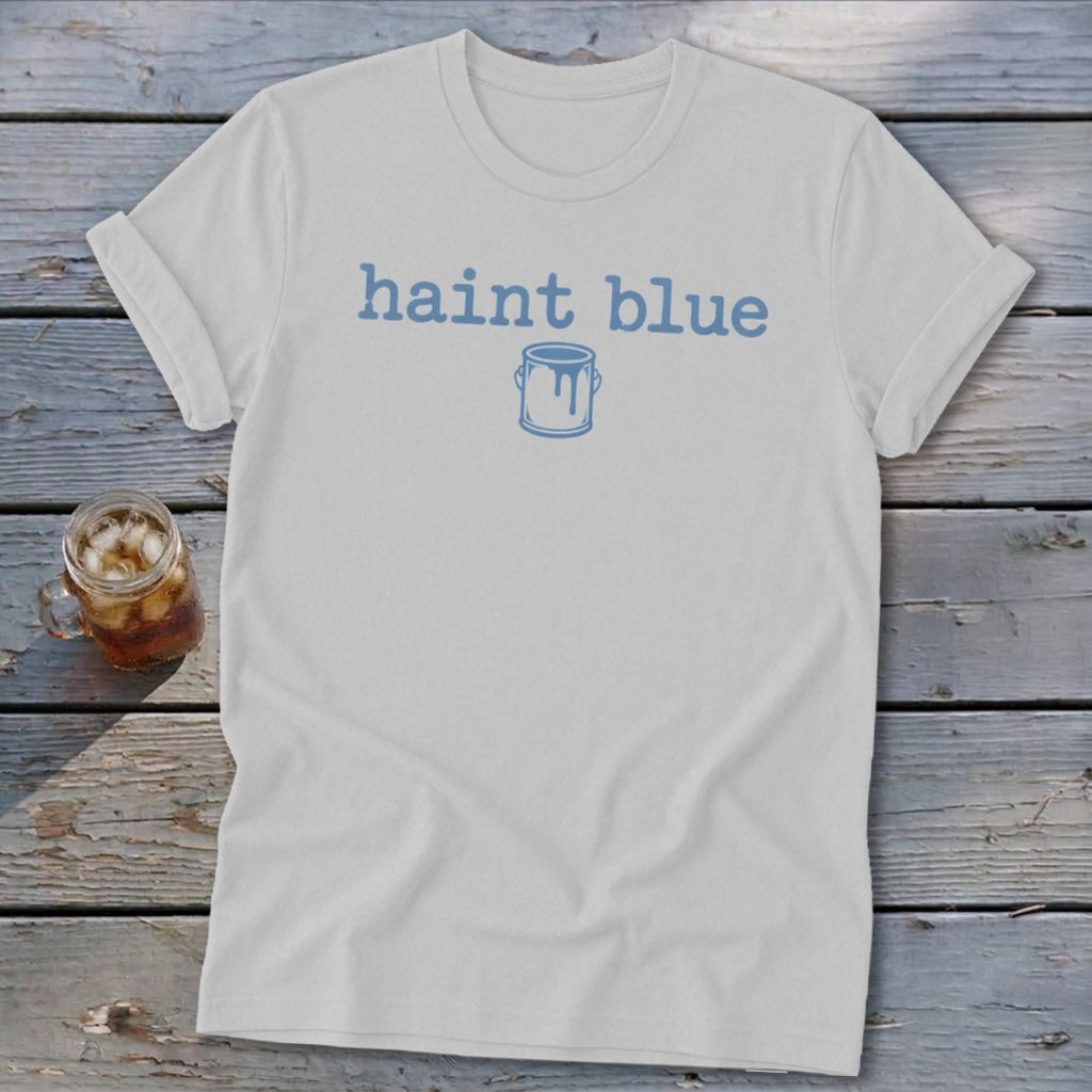 White t-shirt with "haint blue" text and paint can graphic.