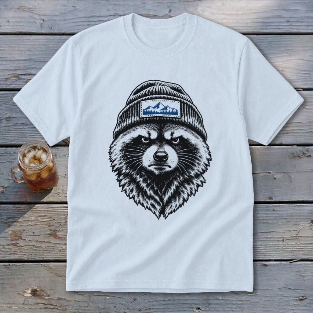 White t-shirt with a black and white illustration of a raccoon wearing a beanie with mountains.