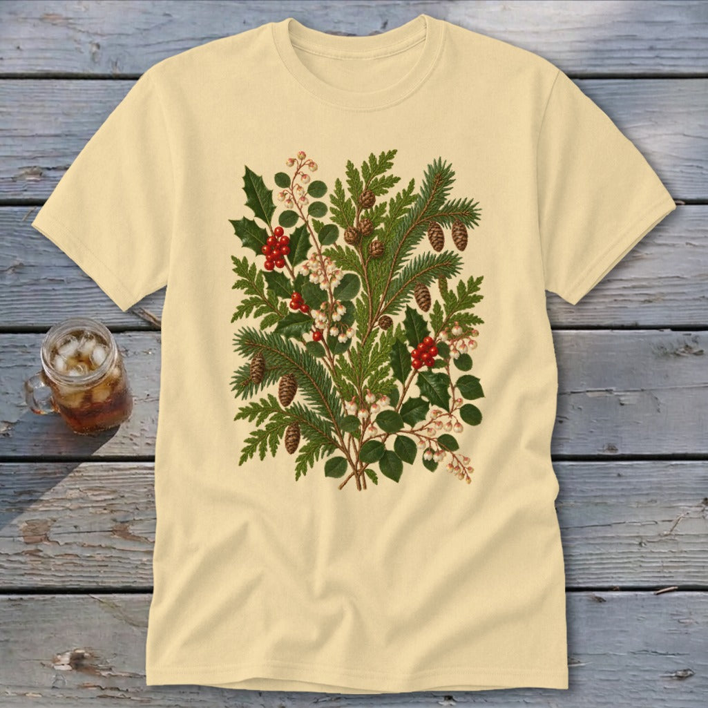 Light yellow t-shirt with a detailed illustration of pine branches, holly, and pinecones.