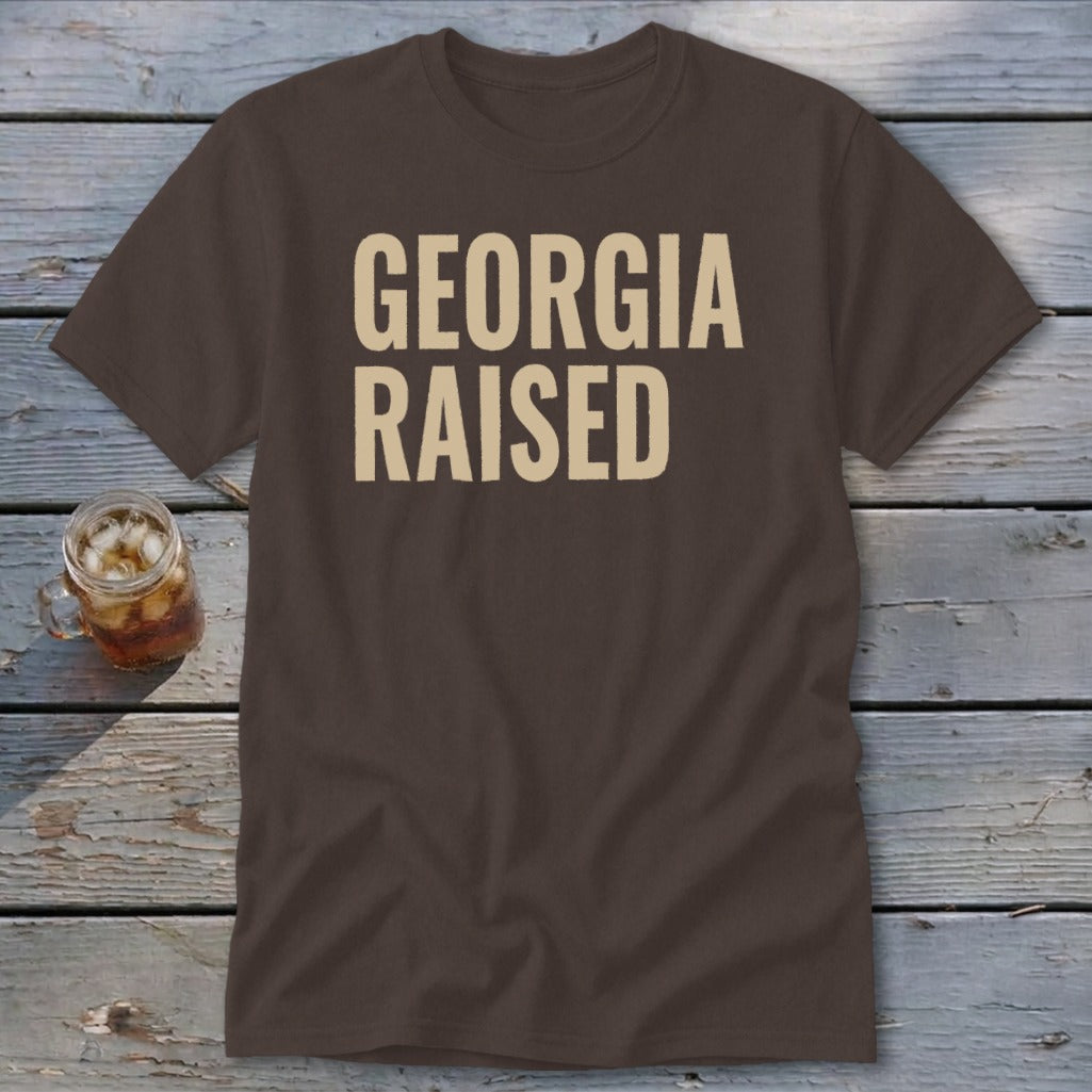 Brown t-shirt with "GEORGIA RAISED" printed in cream lettering.