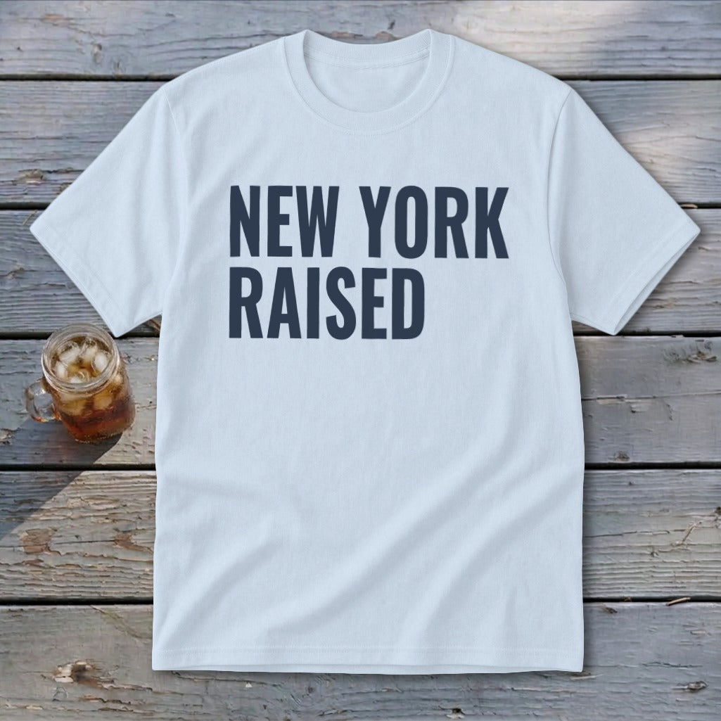 Light blue t-shirt with dark blue text that says "NEW YORK RAISED".