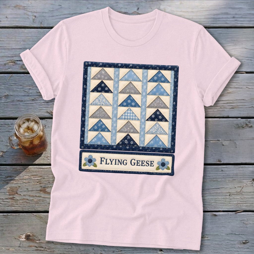 Pink t-shirt with a "Flying Geese" quilt design and blue floral accents.