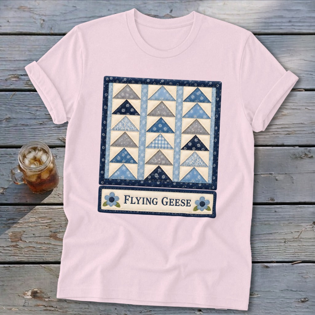Pink t-shirt with a "Flying Geese" quilt design and blue floral accents.