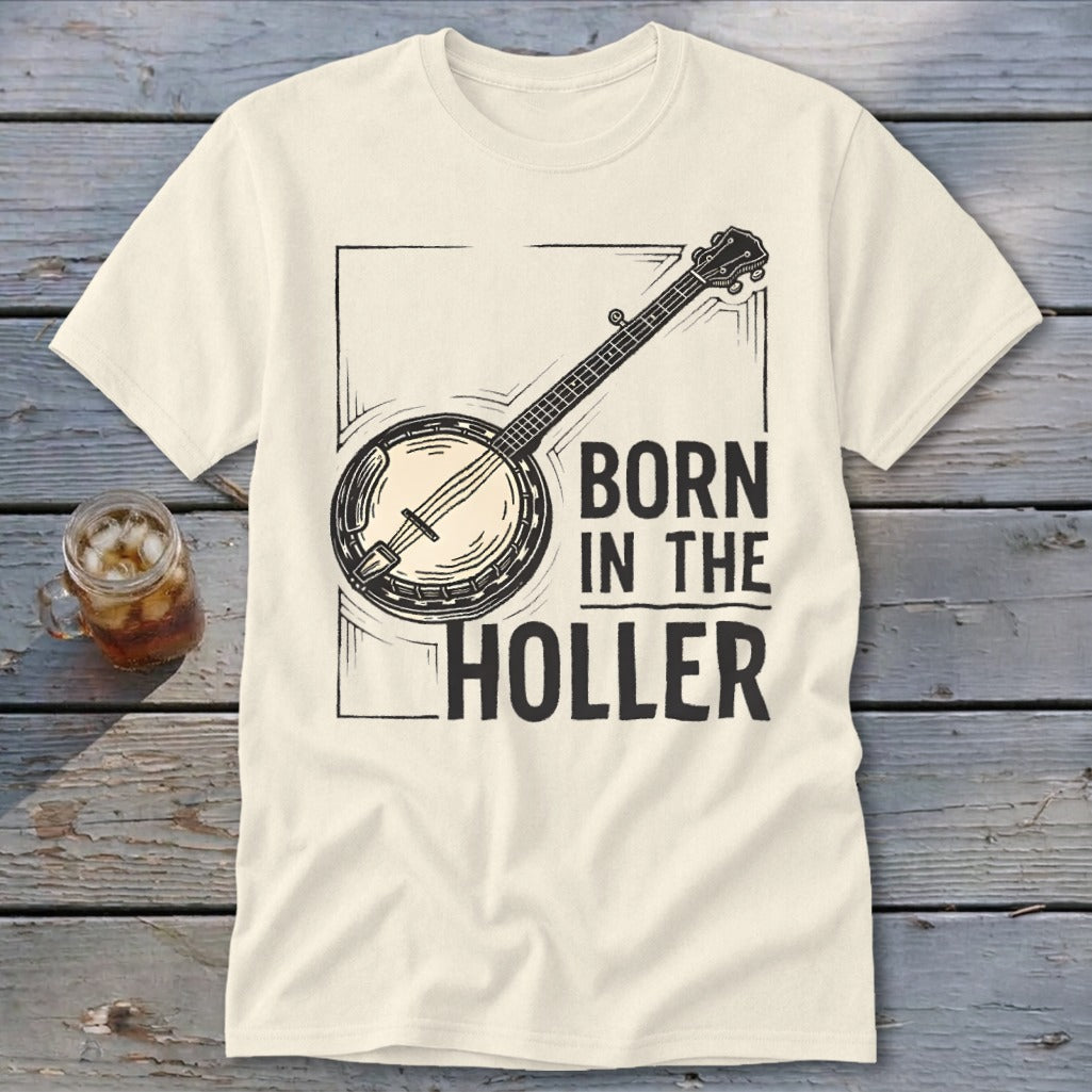Cream t-shirt with banjo graphic and text "BORN IN THE HOLLER".